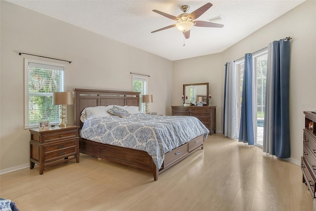 bedroom with light hardwood / wood-style floors, multiple windows, and ceiling fan