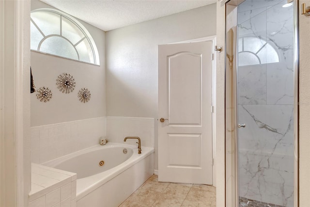 bathroom featuring tile patterned floors, separate shower and tub, a textured ceiling, and plenty of natural light