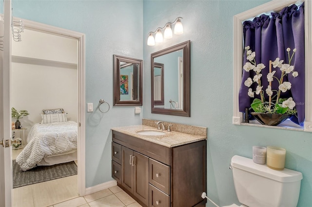 bathroom with tile patterned flooring, toilet, and vanity