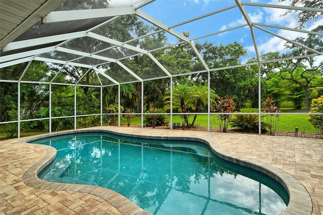 view of pool featuring a patio and glass enclosure