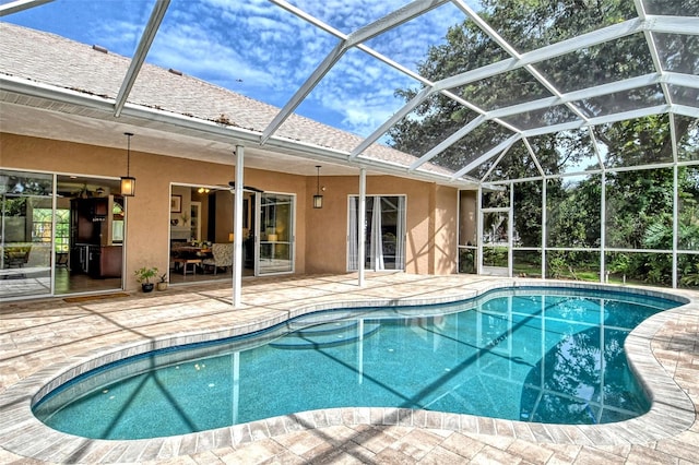 view of swimming pool with a patio area and a lanai