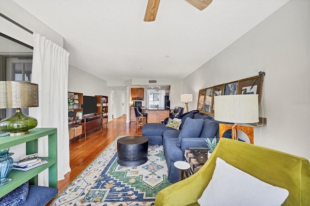 living room with hardwood / wood-style floors and a textured ceiling