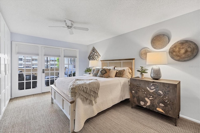 carpeted bedroom featuring ceiling fan, a textured ceiling, access to outside, and french doors