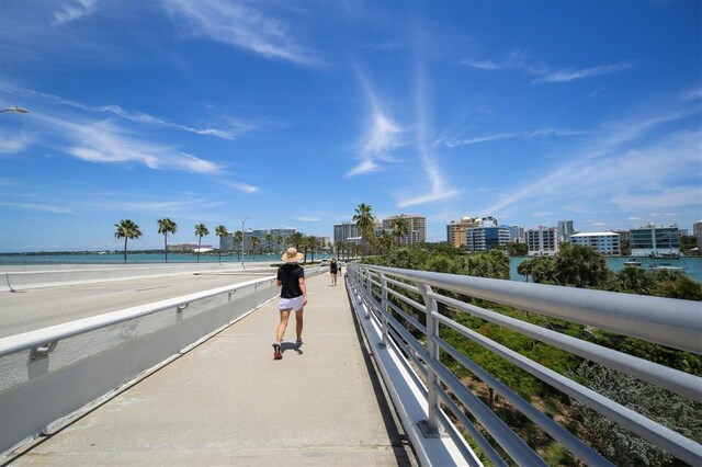 view of property's community featuring a water view and a beach view