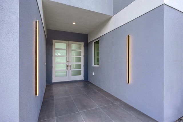 doorway to property featuring french doors and stucco siding