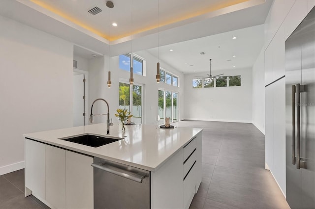 kitchen featuring stainless steel appliances, white cabinets, and sink