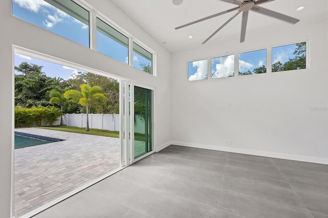 unfurnished sunroom with a pool and ceiling fan