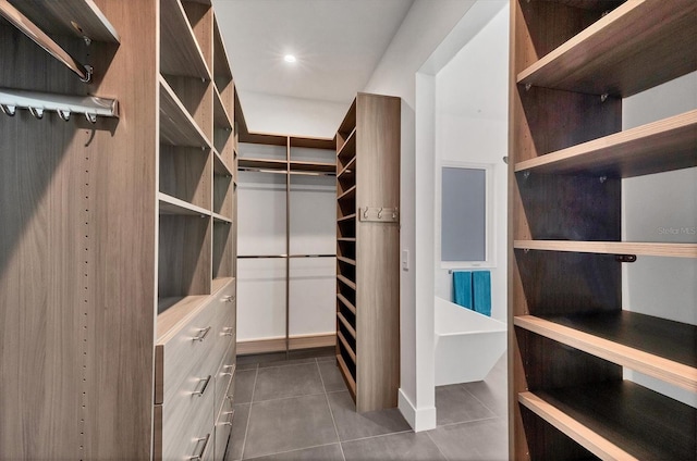 spacious closet featuring dark tile patterned flooring