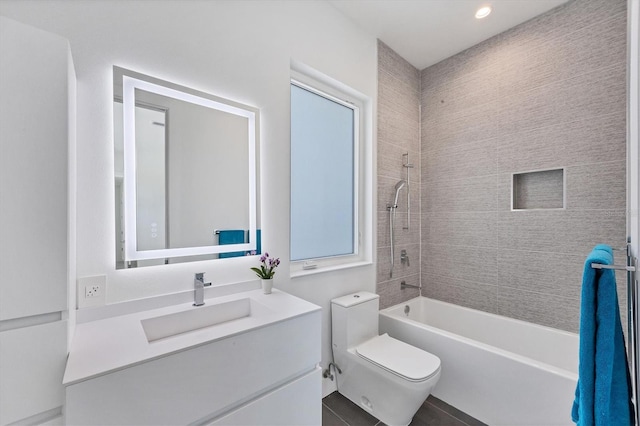 full bathroom with tiled shower / bath combo, vanity, and toilet