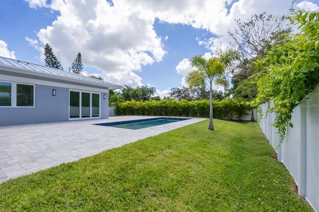 view of yard featuring a fenced in pool and a patio area