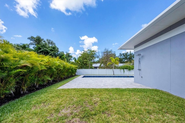 view of yard with a fenced in pool