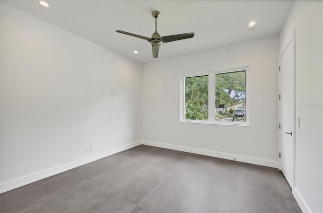 empty room featuring tile patterned flooring and ceiling fan