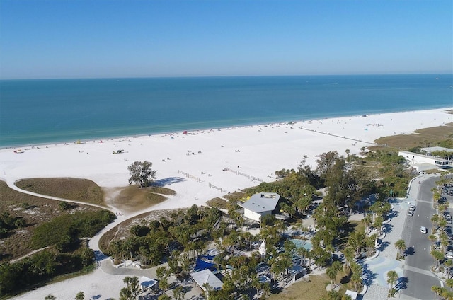 drone / aerial view featuring a water view and a view of the beach