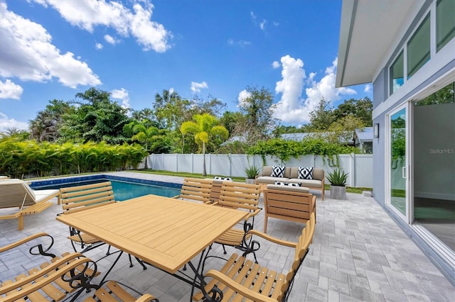 view of pool with outdoor dining space, a fenced in pool, a fenced backyard, and a patio