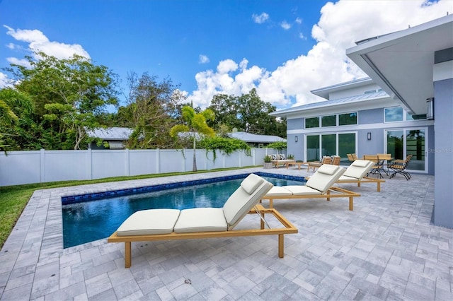 view of swimming pool featuring a patio area, a fenced backyard, and a fenced in pool