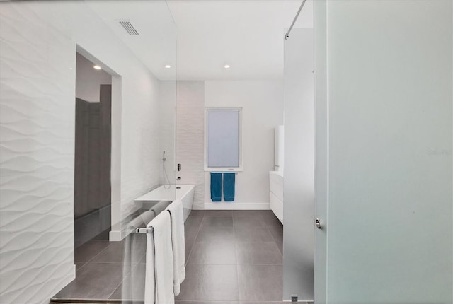 bathroom featuring a bathtub, recessed lighting, visible vents, vanity, and tile patterned flooring