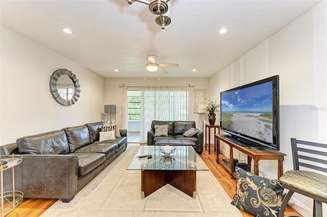 living room featuring ceiling fan and light hardwood / wood-style floors