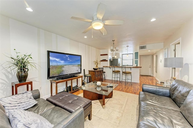 living room featuring ceiling fan and light hardwood / wood-style flooring