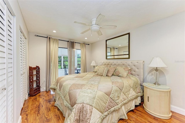 bedroom with hardwood / wood-style flooring, ceiling fan, and access to outside