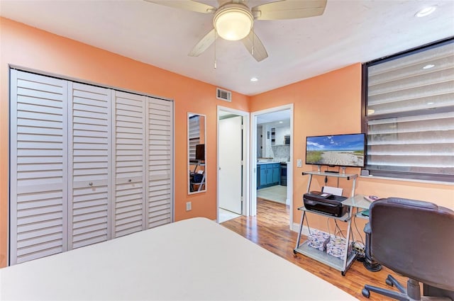 bedroom featuring hardwood / wood-style floors, a closet, and ceiling fan