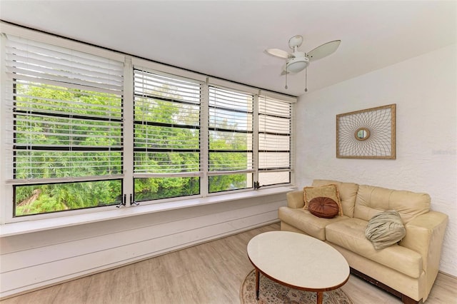 living room featuring wood-type flooring and ceiling fan