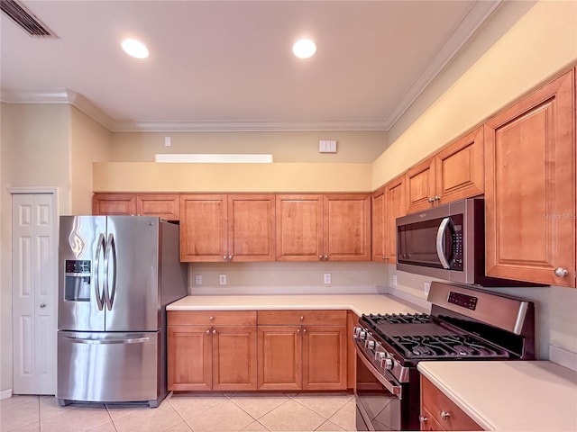 kitchen featuring crown molding, light tile patterned floors, stainless steel appliances, light countertops, and visible vents