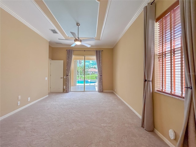 spare room with ornamental molding, visible vents, and baseboards