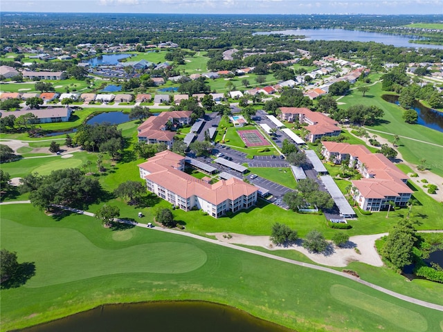 birds eye view of property featuring view of golf course, a water view, and a residential view