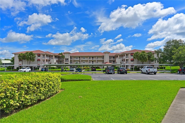 view of property with covered and uncovered parking