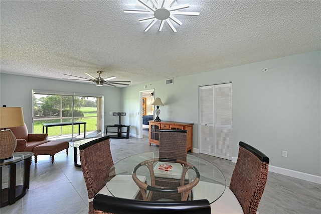 dining space with visible vents, ceiling fan, a textured ceiling, and baseboards