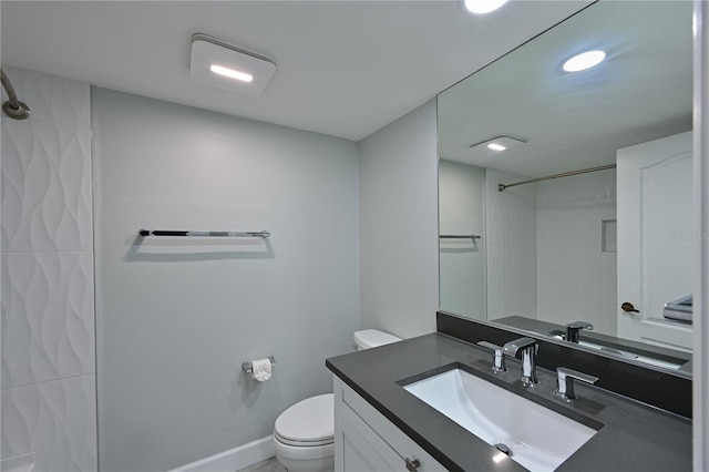 bathroom featuring baseboards, a shower, toilet, vanity, and recessed lighting