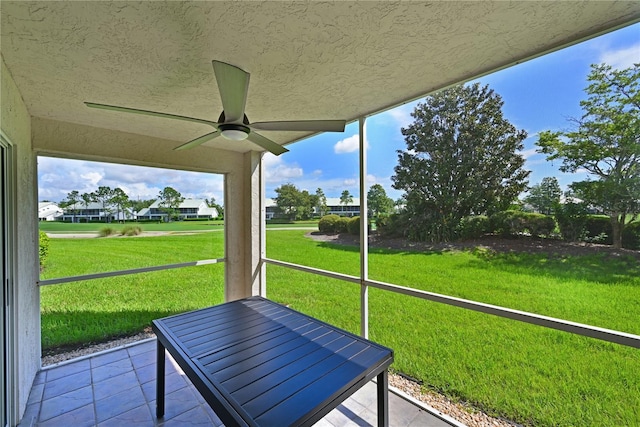 unfurnished sunroom with ceiling fan