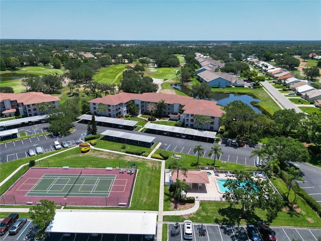 birds eye view of property featuring golf course view and a water view