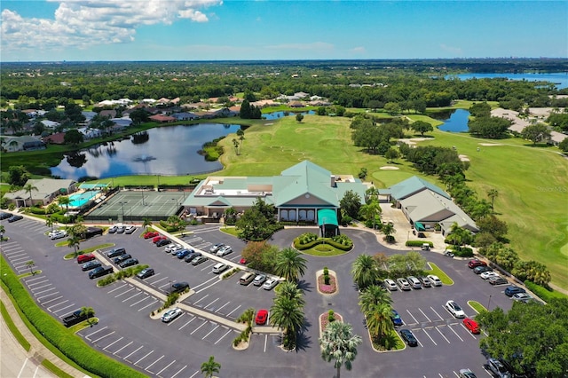 drone / aerial view with a water view and golf course view