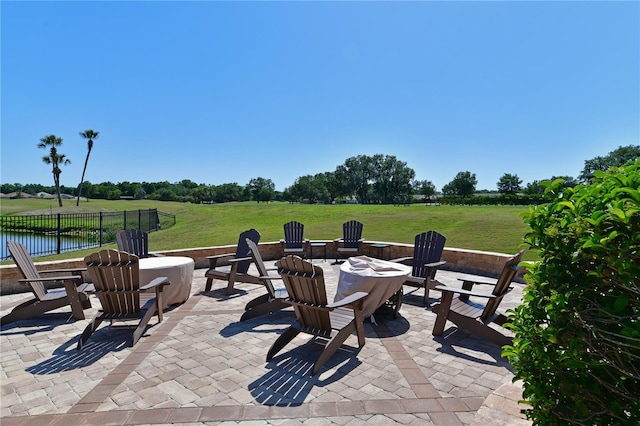 view of patio / terrace featuring fence and a fire pit