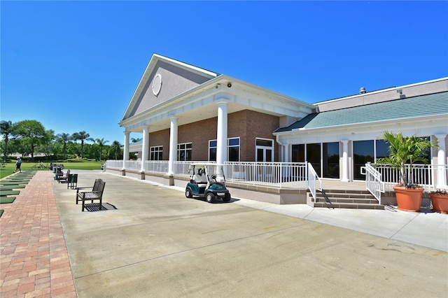 rear view of property with a patio and brick siding