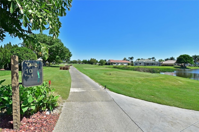 view of property's community featuring a water view and a yard