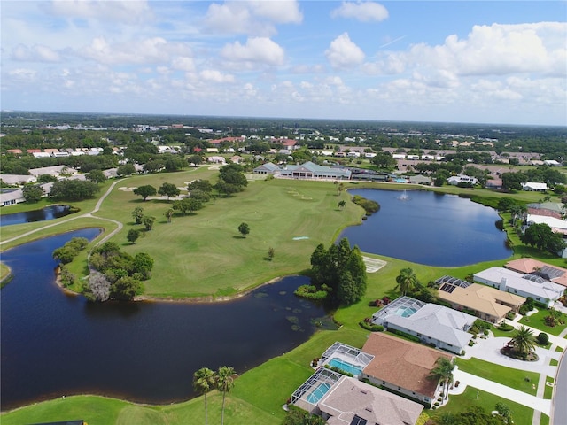 birds eye view of property with golf course view, a water view, and a residential view