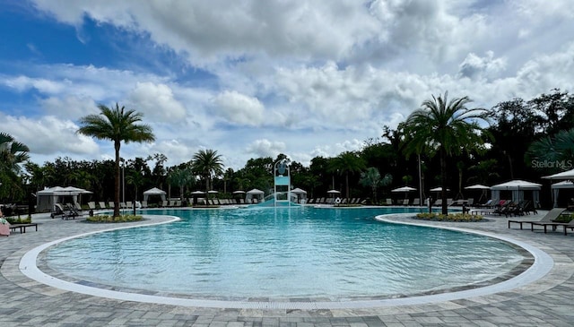 pool featuring a patio area and a water slide