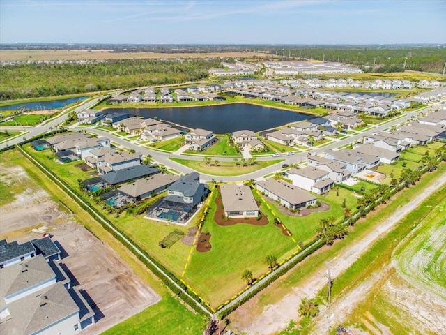 drone / aerial view with a residential view and a water view