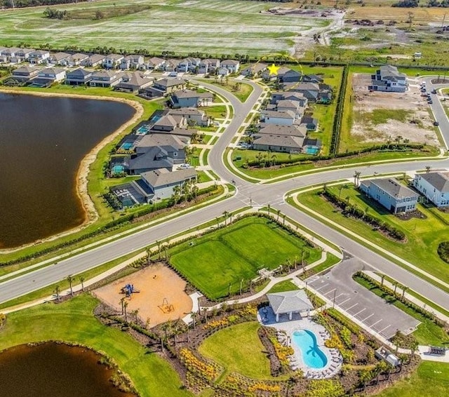 drone / aerial view featuring a water view and a residential view