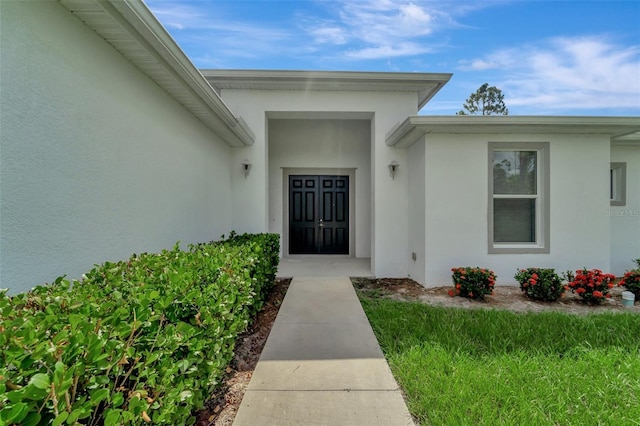 doorway to property with stucco siding