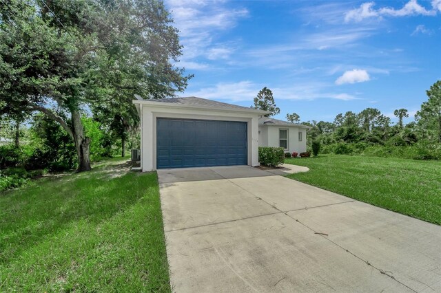 ranch-style home featuring a garage and a front lawn