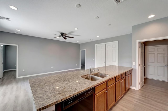 kitchen with ceiling fan, sink, dishwasher, light stone countertops, and light hardwood / wood-style flooring