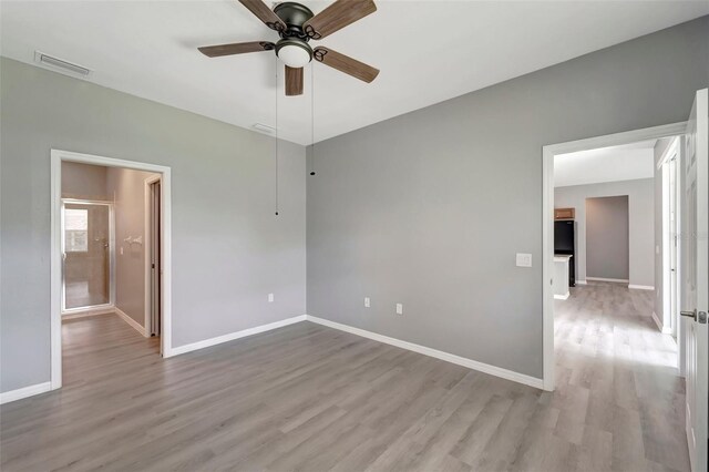 spare room featuring wood-type flooring and ceiling fan