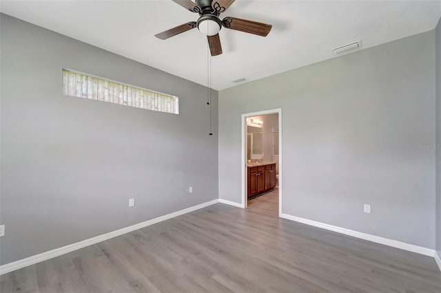 unfurnished room with ceiling fan and hardwood / wood-style flooring