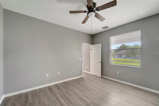 empty room with light wood-type flooring and ceiling fan