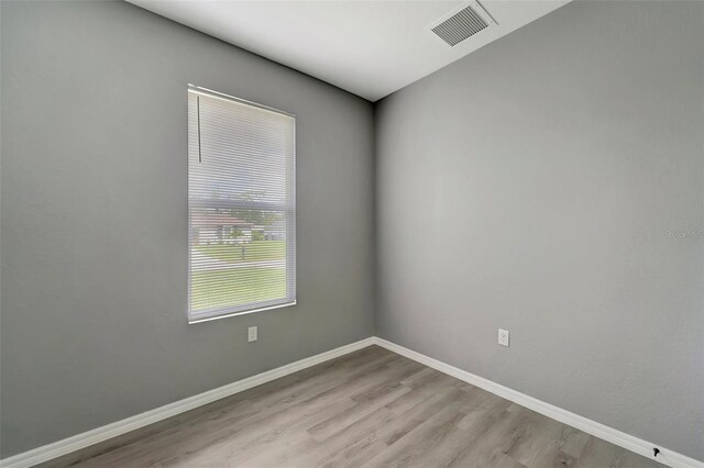 unfurnished room featuring hardwood / wood-style floors