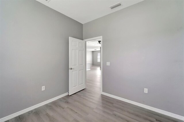 spare room featuring wood-type flooring and ceiling fan