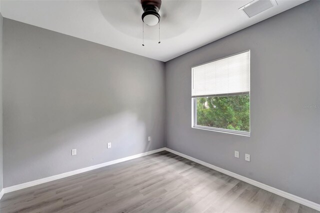 empty room featuring hardwood / wood-style floors and ceiling fan